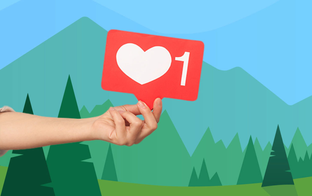Hand holding "like" in front of illustrated trees